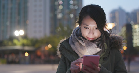 Woman look at smart phone at night