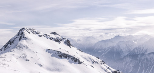 Fototapeta na wymiar Snowy mountain with mountains in the background