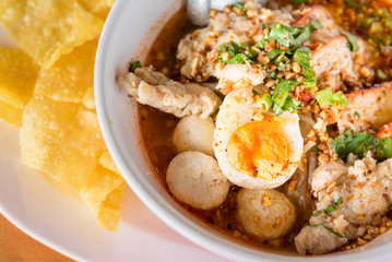 Asian noodle soup with roasted pork and fish ball, Thai style spicy noodle soup.Tom-yum soup.