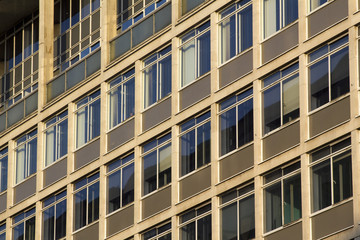 Full frame pattern of windows in a 60's or 70's style office block in London, UK