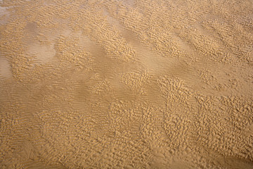 Ripples in the sand and seawater texture