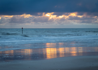 Blyth Beach, Northumberland, England, UK. Heavy rain clouds loom over the coast on a moody morning.