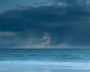 Blyth Beach, Northumberland, England, UK. Heavy rain clouds loom over the coast on a moody morning.