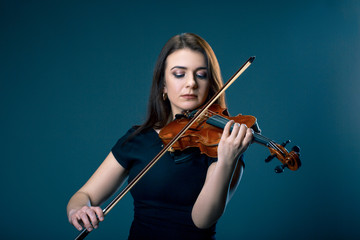 Woman with violin on blue grey background