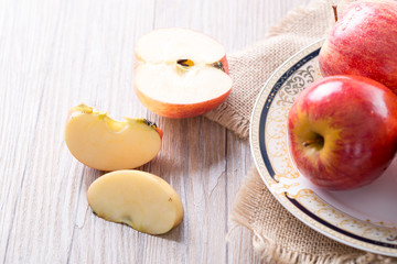 Fresh red apple and slices on wooden table. Closeup