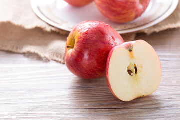 Fresh red apple and slices on wooden table. Closeup