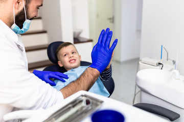 Young boy receiving dental treatment in dentist office