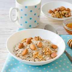 Healthy breakfast of muesli with nuts, honey and milk