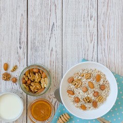 Healthy breakfast of muesli with nuts, honey and milk