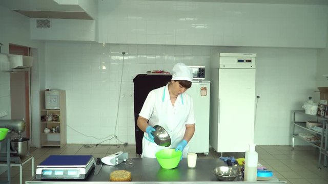Adding flour to the dough. Chef hands pouring white flour to the dough in bowl.
