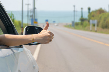 travel hand thumbs In the car on the road