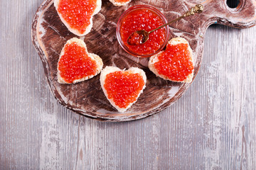 Red caviar over heart shape bread