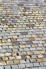 Old weathered multi coloured roof slate tiles full frame