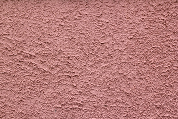 Colourful salmon pink rough rendered wall texture full frame