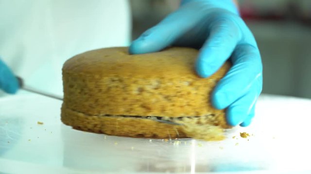 confectioner cuts cake into layers