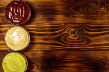 Set of sauces on wooden table