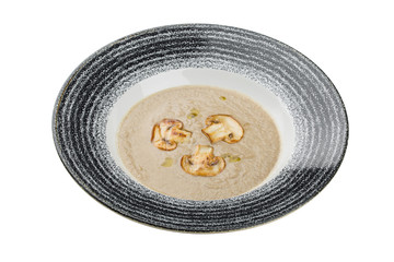 Mushroom cream soup in a plate. Isolated on a white backgorund.
