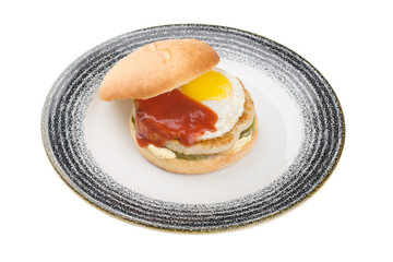 Chiken burger with egg on a plate. isolated on a white background