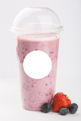 Fruit smoothie in a plastic cup. Isolated ob a white background.