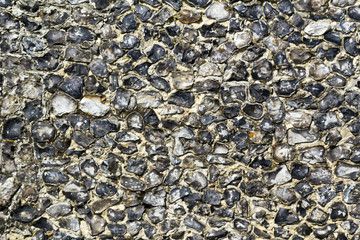 Old traditional flint infill wall close up full frame