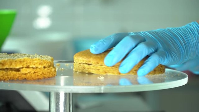 confectioner cuts cake into layers