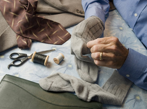 business man darning socks