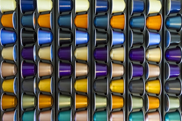 Fototapeta premium Different colors aluminium coffee capsule. Luxury premium background for the store with coffee capsule.