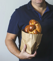 Sweet Challah bread in hand