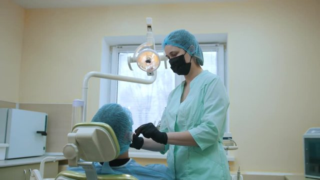 Doctor stomatologist and patient in the dental office, inspection and examination the mouth