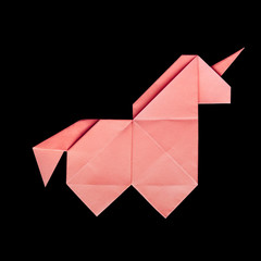 Handmade pink trendy geometrical polygonal  paper origami unicorn on black background isolated © mykolastock