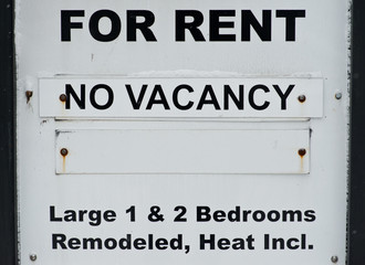 For rent no vacancy sign before old apartment building