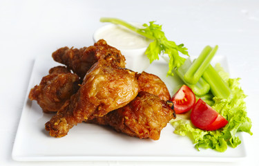 Fried chicken drumsticks and vegetables