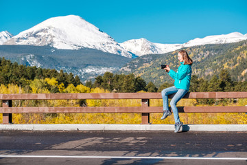 Tourist taking photo in Rocky Mountains at autumn, Colorado, USA.