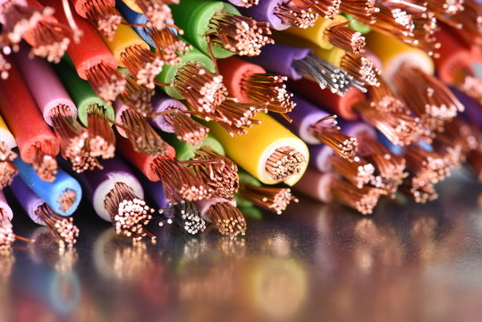 Colored copper electic cables closeup on metal surface with reflexion