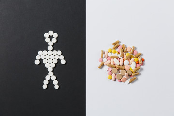 Medication white colorful round tablets arranged abstract on white black background. Human, aspirin, capsule pills design. Treatment, choice healthy lifestyle concept. Copy space for advertisement.