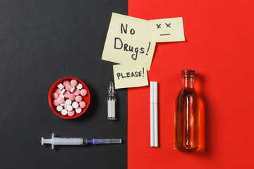 Medication colorful round tablets pills empty syringe needle, bottle alcohol ampoule cigarettes on black red background. Paper sticker sheet text appeal no drugs. Treatment choice healthy lifestyle.