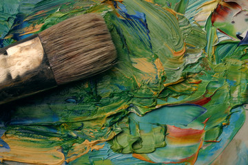 Fototapeta premium Close up of artists palette, oil paints and brush