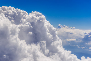 Naklejka na ściany i meble Cumulus cloudscape seen from a window plane