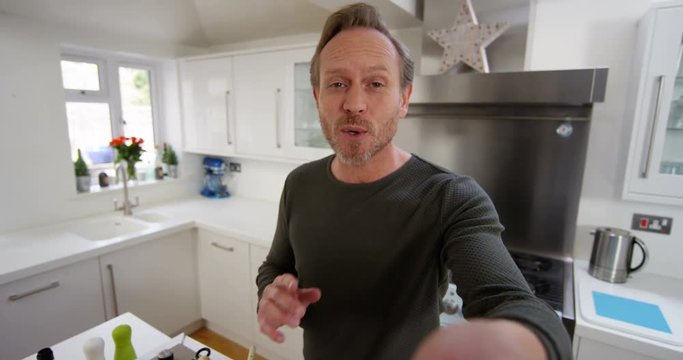 4k, Attractive man video blogging on his smartphone proudly showing off a freshly prepared cuisine.