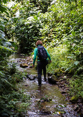 Obraz premium Hiking woman in stream
