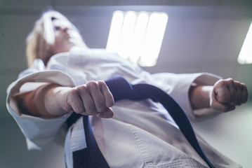 Woman who is exercised practicing karate © karrastock
