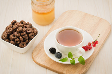 breakfast on a wooden tray with tea, honey and flakes/breakfast on a wooden tray with tea, honey and flakes. top view