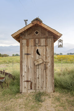 An old, wooden, outside toilet building in California