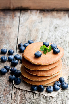 Stack  of scotch pancakes with fresh blueberry on wooden table