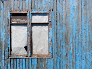 Very old grunged blue wall and wooden window