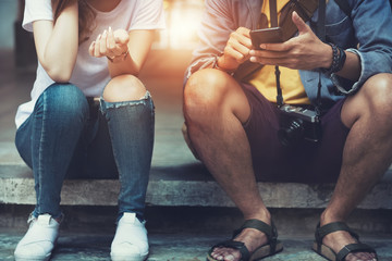 hipster girl and boy posing in the street with using smartphone, Their story, post in instagram, facebook
