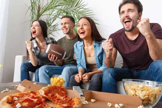 Group of friends sport fans watching rugby match victory
