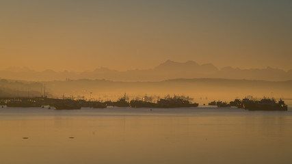 Obraz premium Sunrise in the harbour of Quellon in Chiloe Island. Patagonia in Chile