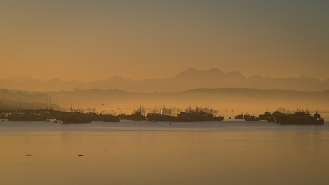 Sunrise in the harbour of Quellon in Chiloe Island. Patagonia in Chile