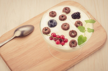 yogurt with chocolate flakes, berries and mint on a wooden tray/yogurt with chocolate flakes, berries and mint on a wooden tray. Copy space. Top view